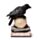 Corvo empoleirado numa caveira LED e livros