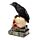Corvo empoleirado numa caveira e livros